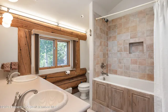 a bathroom with a granite countertop sink and a bathtub