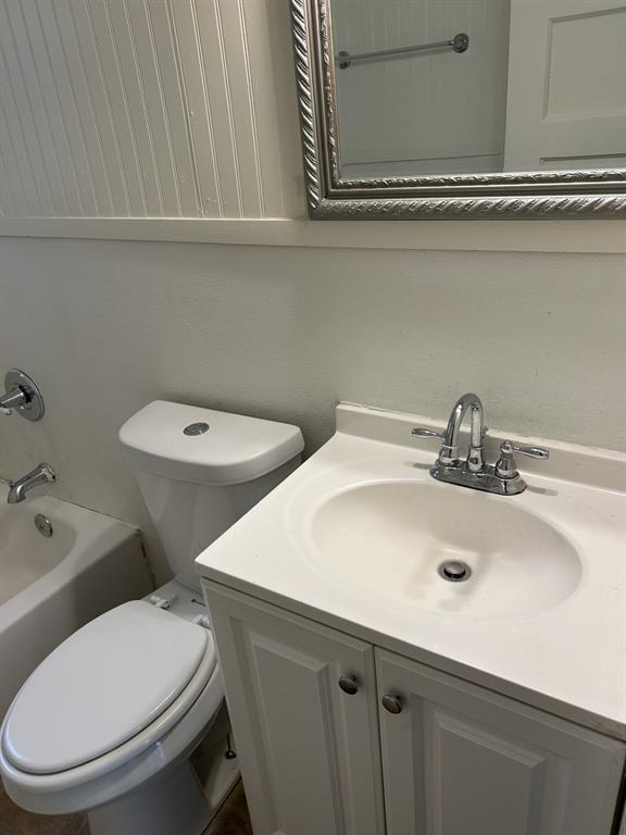 6318 Belgrade Avenue Dallas, TX 75227 - Photo 18 of 23 a bathroom with a toilet a sink and mirror