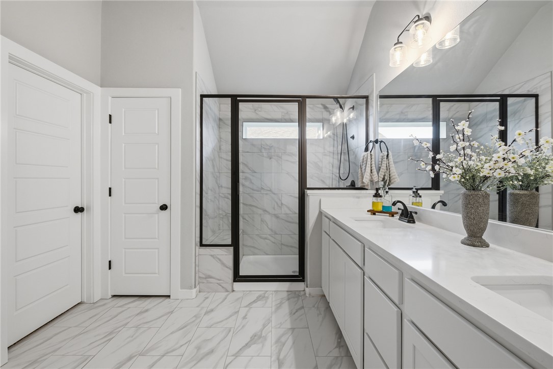 3112 Margaret Rudder Parkway Bryan, TX 77808 - Photo 16 of 24 a bathroom with a double vanity sink and a mirror
