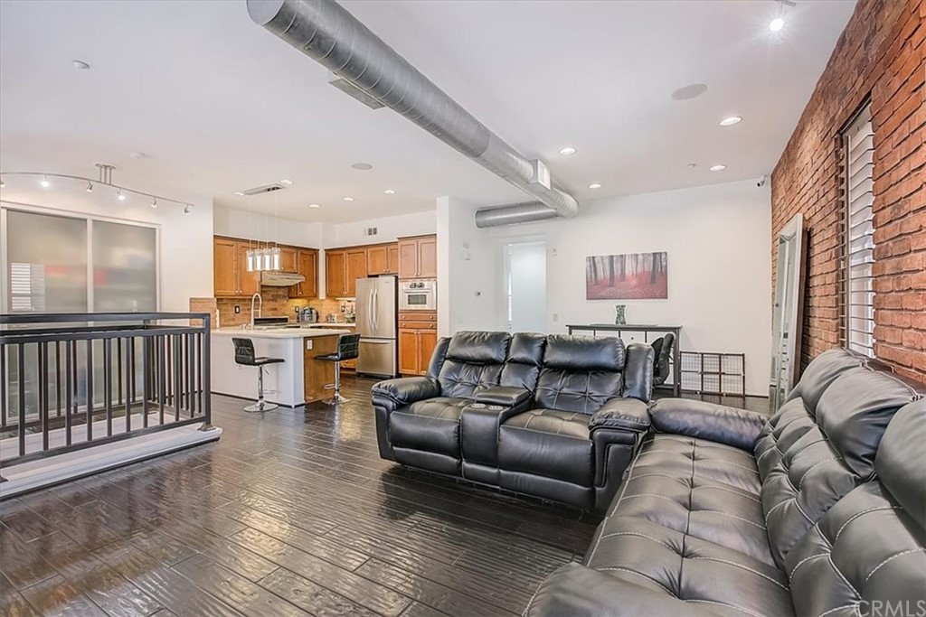 326 District Court Fullerton, CA 92832 - Photo 17 of 41 a living room with furniture kitchen view and a wooden floor