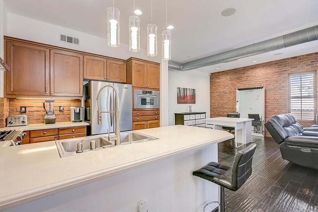 326 District Court Fullerton, CA 92832 - Photo 22 of 41 a kitchen with stainless steel appliances granite countertop a sink refrigerator and cabinets