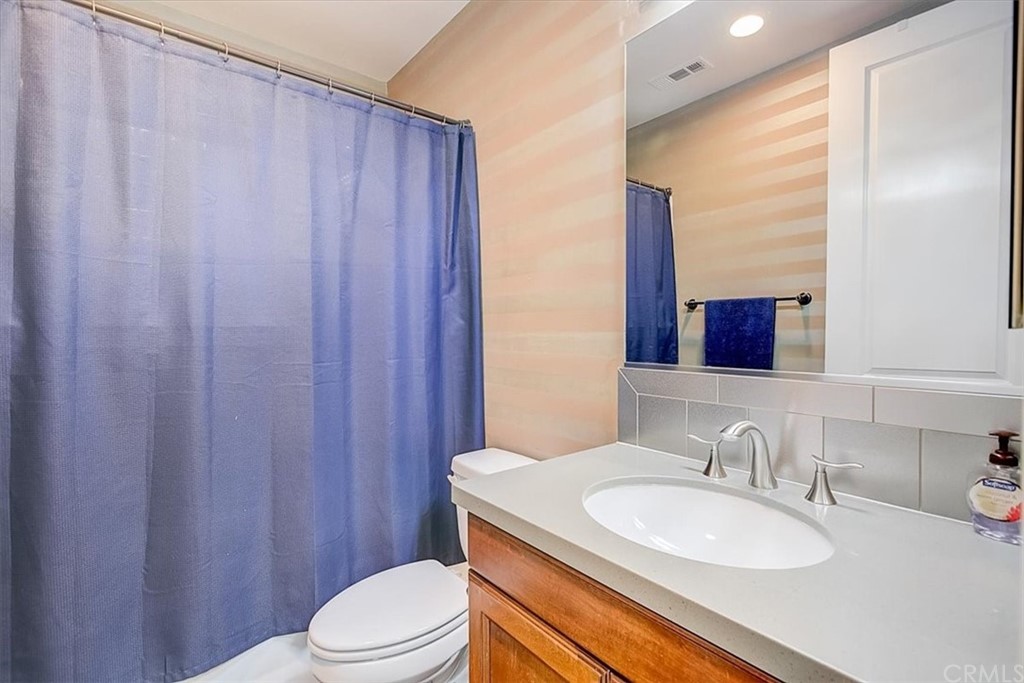 326 District Court Fullerton, CA 92832 - Photo 25 of 41 a bathroom with a sink a toilet and shower curtain