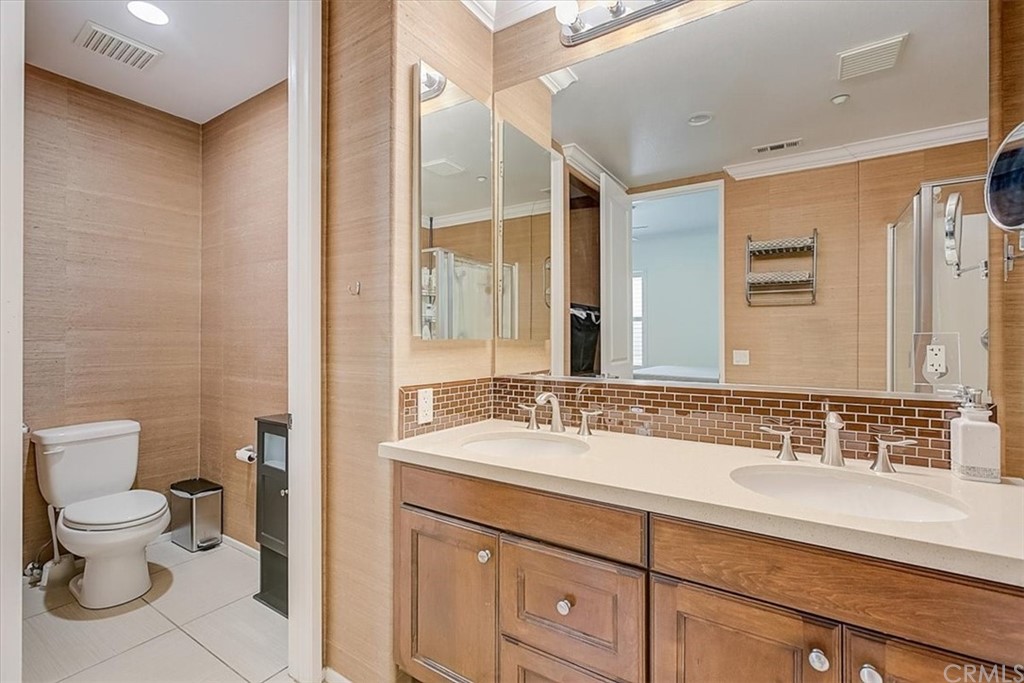 326 District Court Fullerton, CA 92832 - Photo 34 of 41 a bathroom with a sink a toilet a mirror and shower