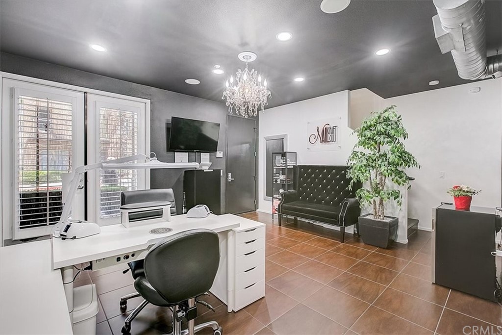 326 District Court Fullerton, CA 92832 - Photo 7 of 41 a workspace with furniture and a potted plant