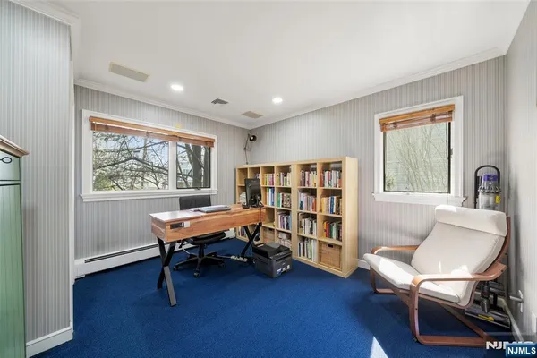 a view of a livingroom with workspace and a window