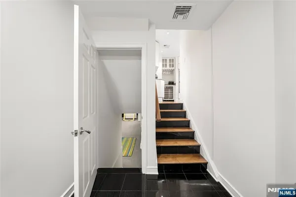 a view of a hallway with wooden floor and entryway
