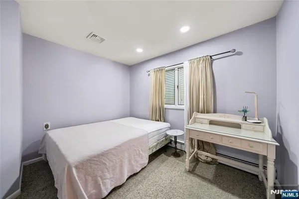 a spacious bedroom with a bed and a table