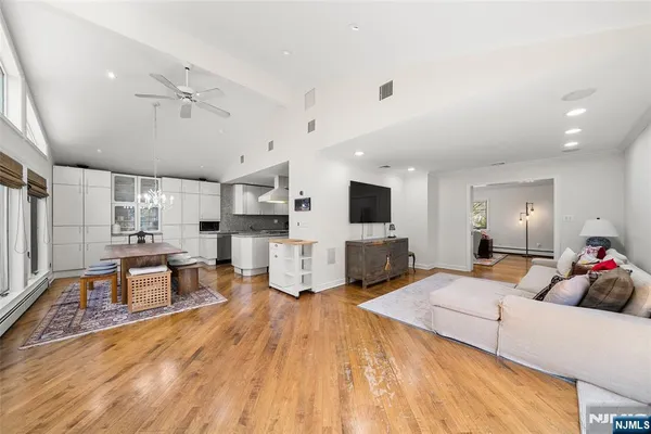 a large room with lots of furniture and flat screen tv