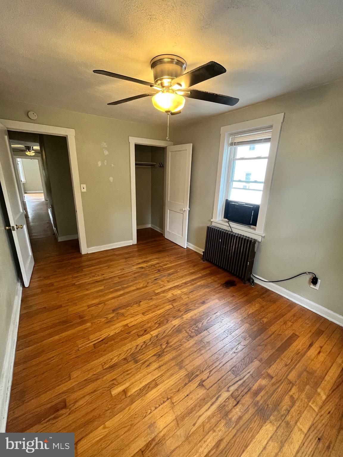 11 New Street, Unit 4 Newark, DE 19711 - Photo 13 of 16 a view of an empty room with wooden floor and a window