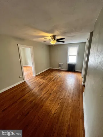 a view of a room with wooden floors and stairs