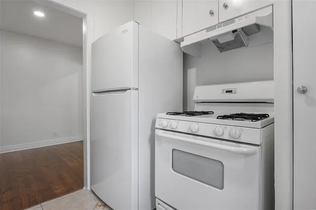 a kitchen with a stove and a refrigerator