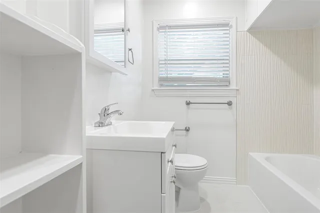a bathroom with a sink a toilet and a bathtub