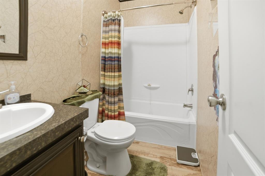 127 Almond Road Minden, LA 71055 - Photo 17 of 25 a bathroom with a granite countertop toilet sink and shower