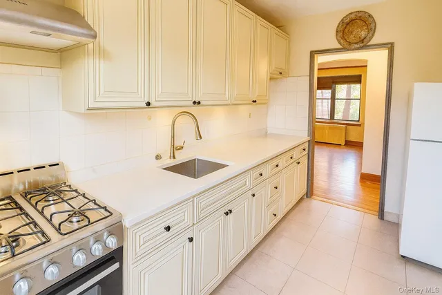 a kitchen with cabinets a stove and a window