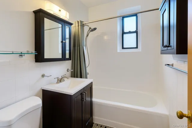 a bathroom with a sink vanity tub and shower