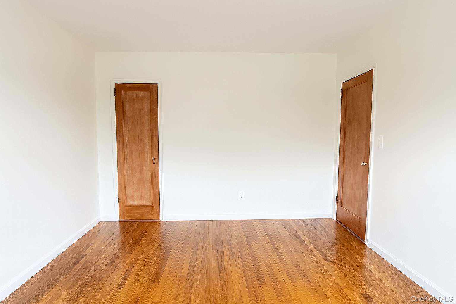 21-41 78th Street, Unit 1 Queens, NY 11370 - Photo 7 of 10 a view of an empty room with wooden floor
