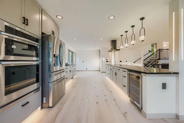 a kitchen with stainless steel appliances a stove a sink and a refrigerator