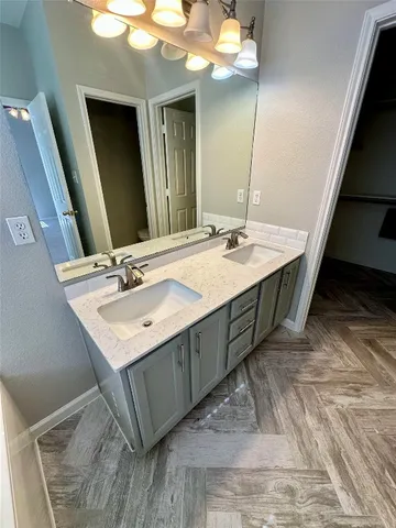 a bathroom with a sink vanity and a mirror