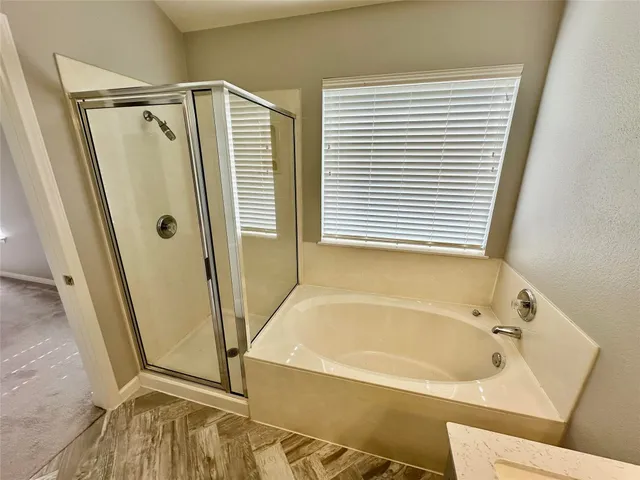 a bathroom with a tub and a shower