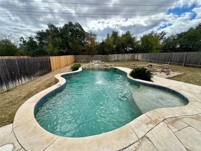 a view of a swimming pool with a yard