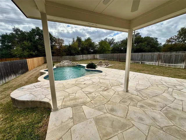 a view of a sink and backyard with a slide