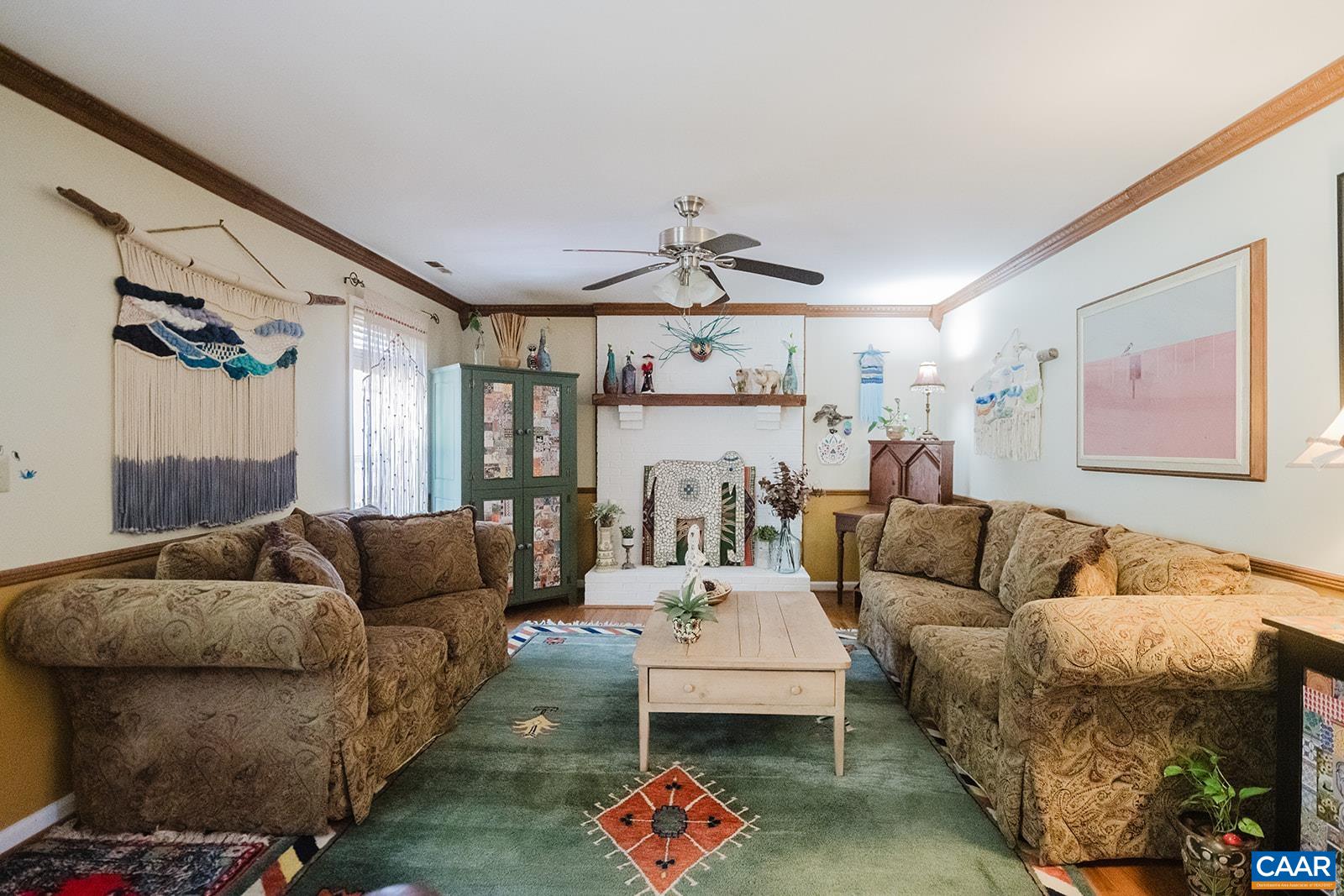 1642 Polo Grounds Road Charlottesville, VA 22911 - Photo 25 of 44 a living room with furniture and a chandelier