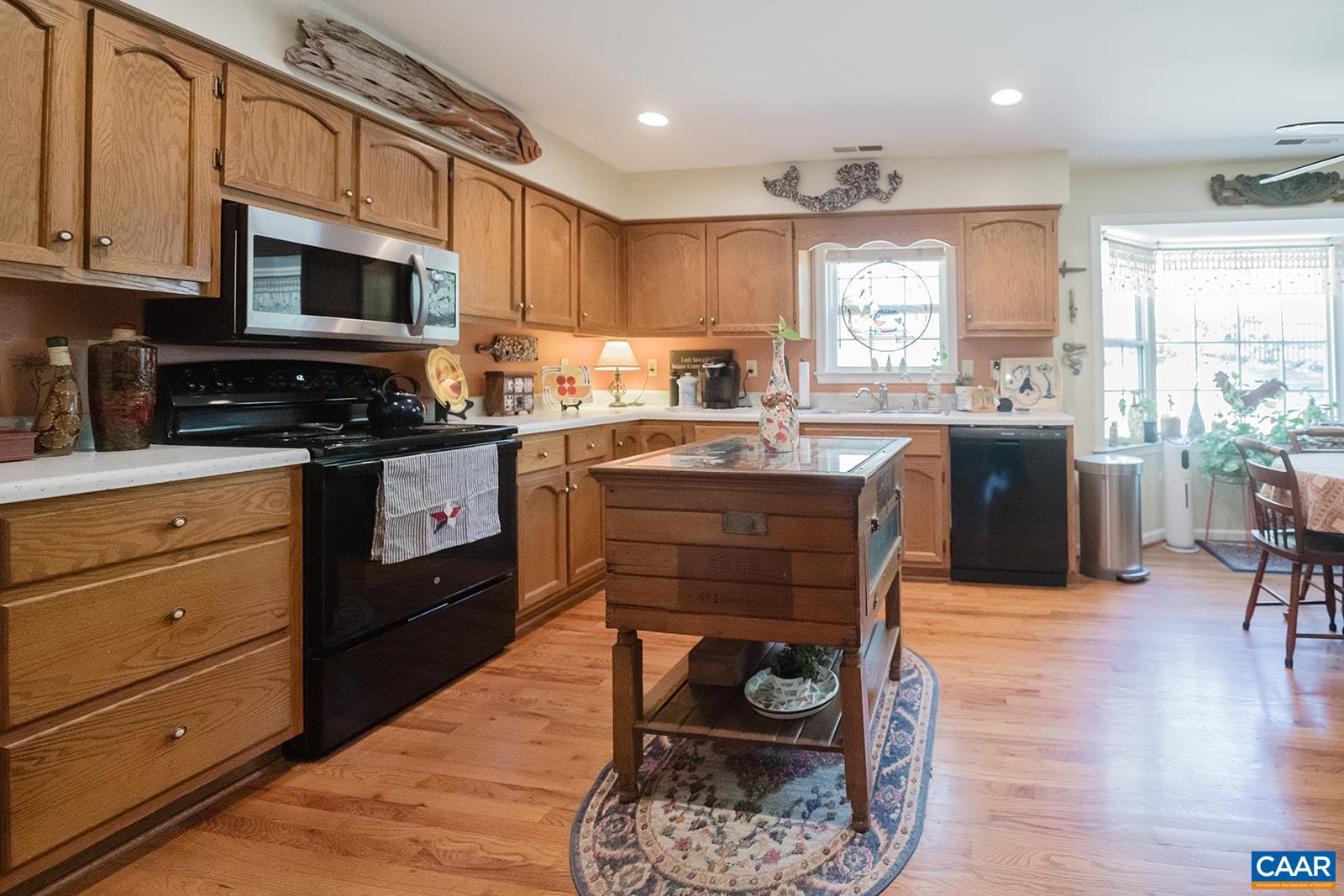 1642 Polo Grounds Road Charlottesville, VA 22911 - Photo 30 of 44 a kitchen with a stove a sink and a microwave