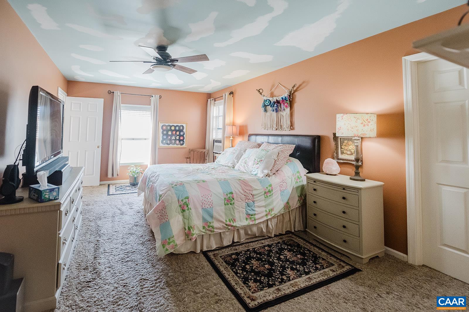 1642 Polo Grounds Road Charlottesville, VA 22911 - Photo 35 of 44 a bed room with a bed furniture and a flat screen tv