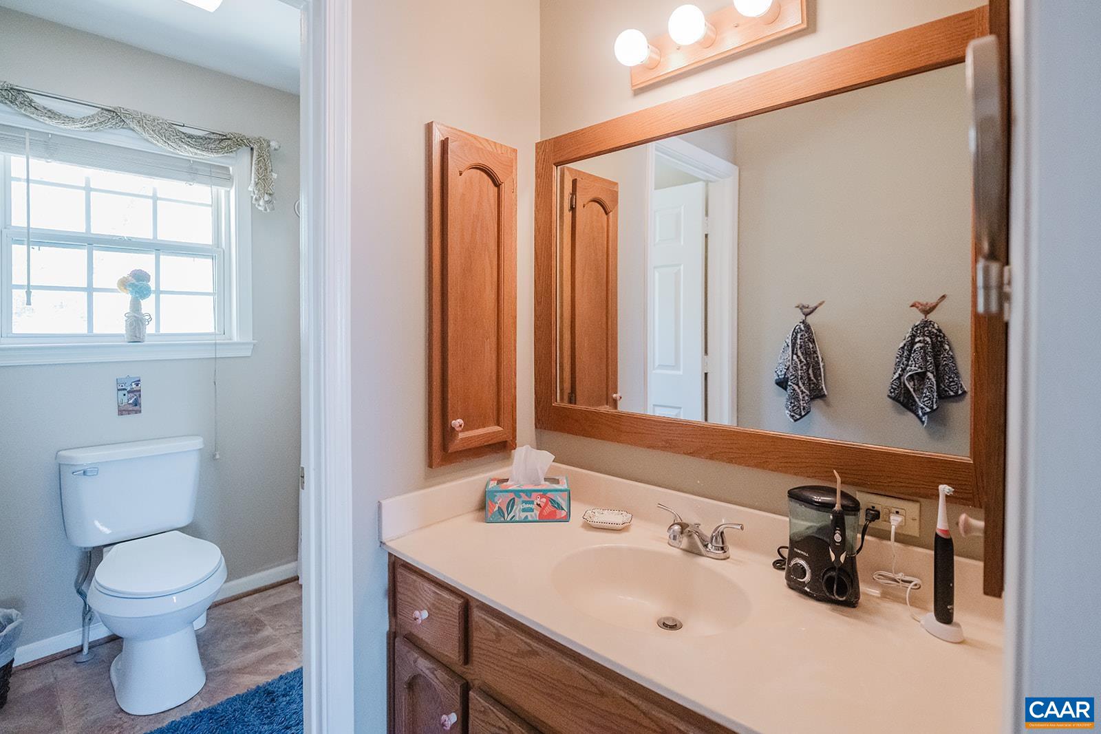 1642 Polo Grounds Road Charlottesville, VA 22911 - Photo 37 of 44 a bathroom with a sink a toilet and shower curtain