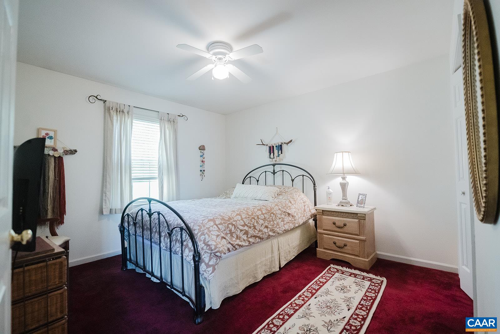 1642 Polo Grounds Road Charlottesville, VA 22911 - Photo 40 of 44 a bedroom with a bed and a chandelier