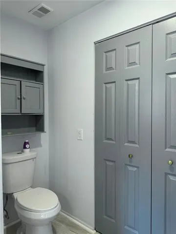 a white toilet sitting next to a bathroom sink