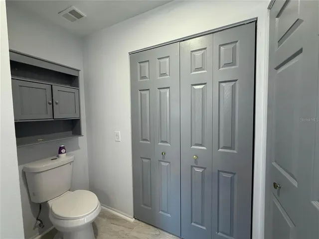 a white toilet sitting next to a bathroom sink