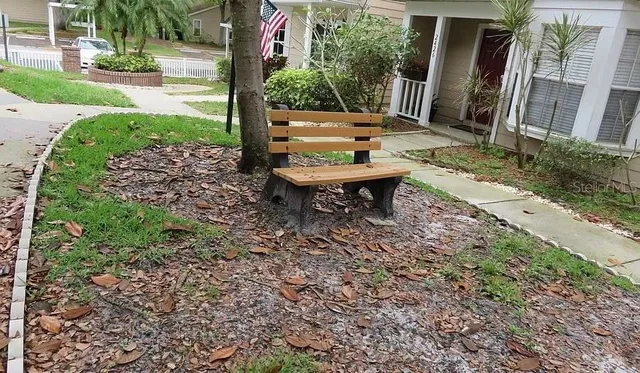 a backyard of a house with table and chairs