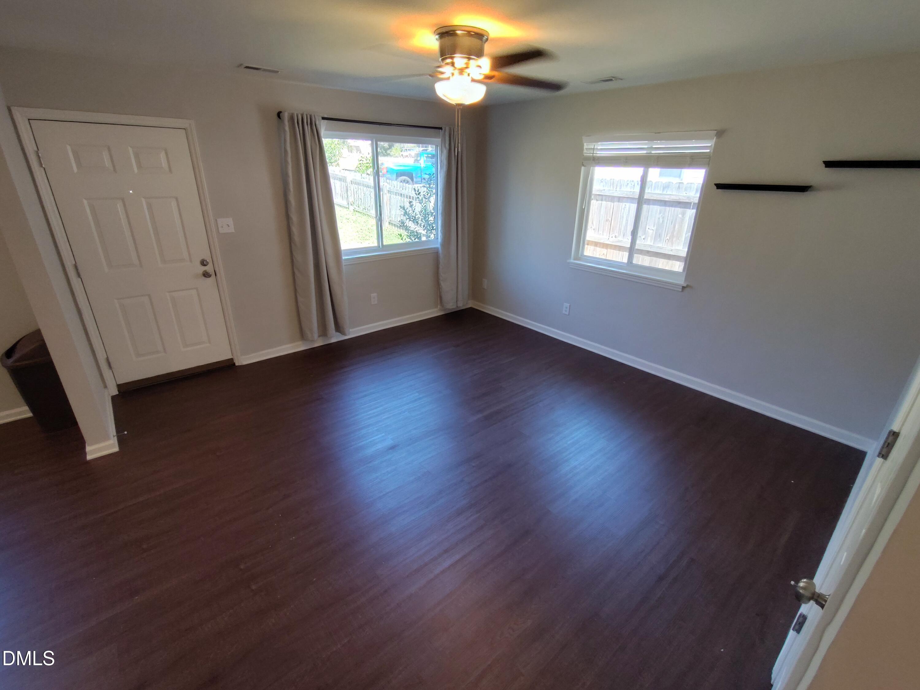 1202 Liberty Street Durham, NC 27703 - Photo 6 of 14 a view of an empty room with wooden floor and a window