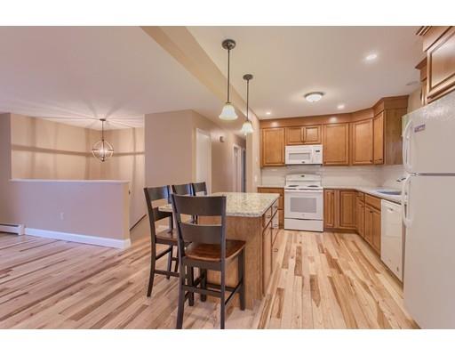 42 Corey Hill Road Ashburnham, MA 01430 - Photo 8 of 27 a kitchen with stainless steel appliances granite countertop a refrigerator a microwave oven a sink with island and chairs