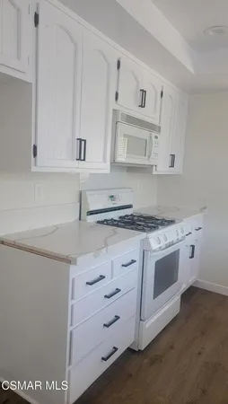 a kitchen with stainless steel appliances granite countertop a sink and a stove