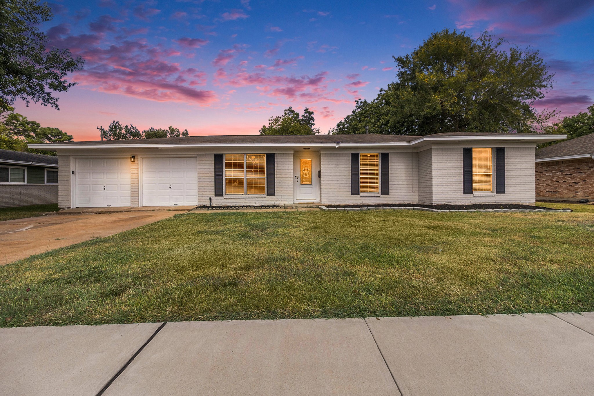 a front view of a house with a garden