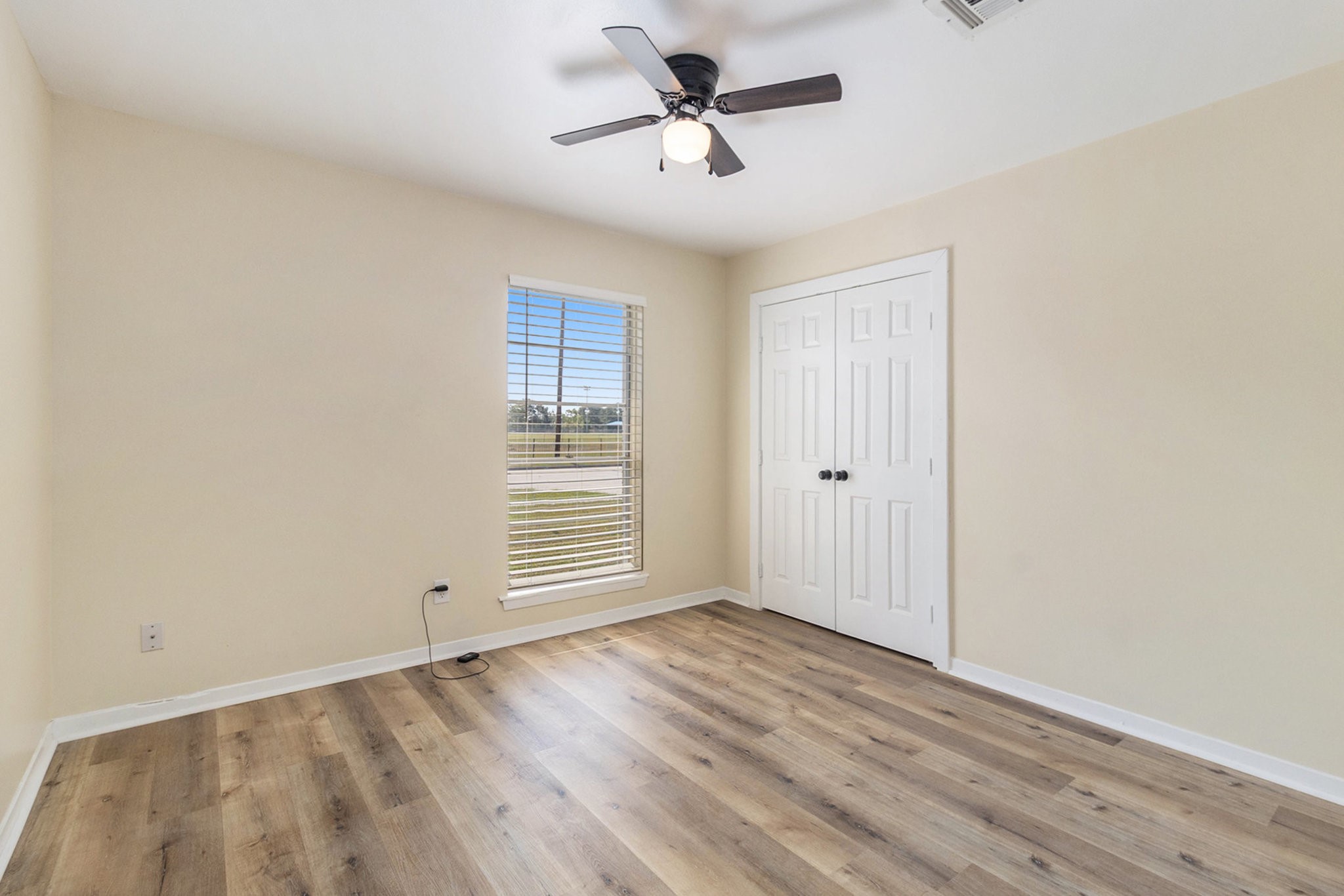 10331 Collingswood Road La Porte, TX 77571 - Photo 13 of 29 a view of empty room with wooden floor and fan