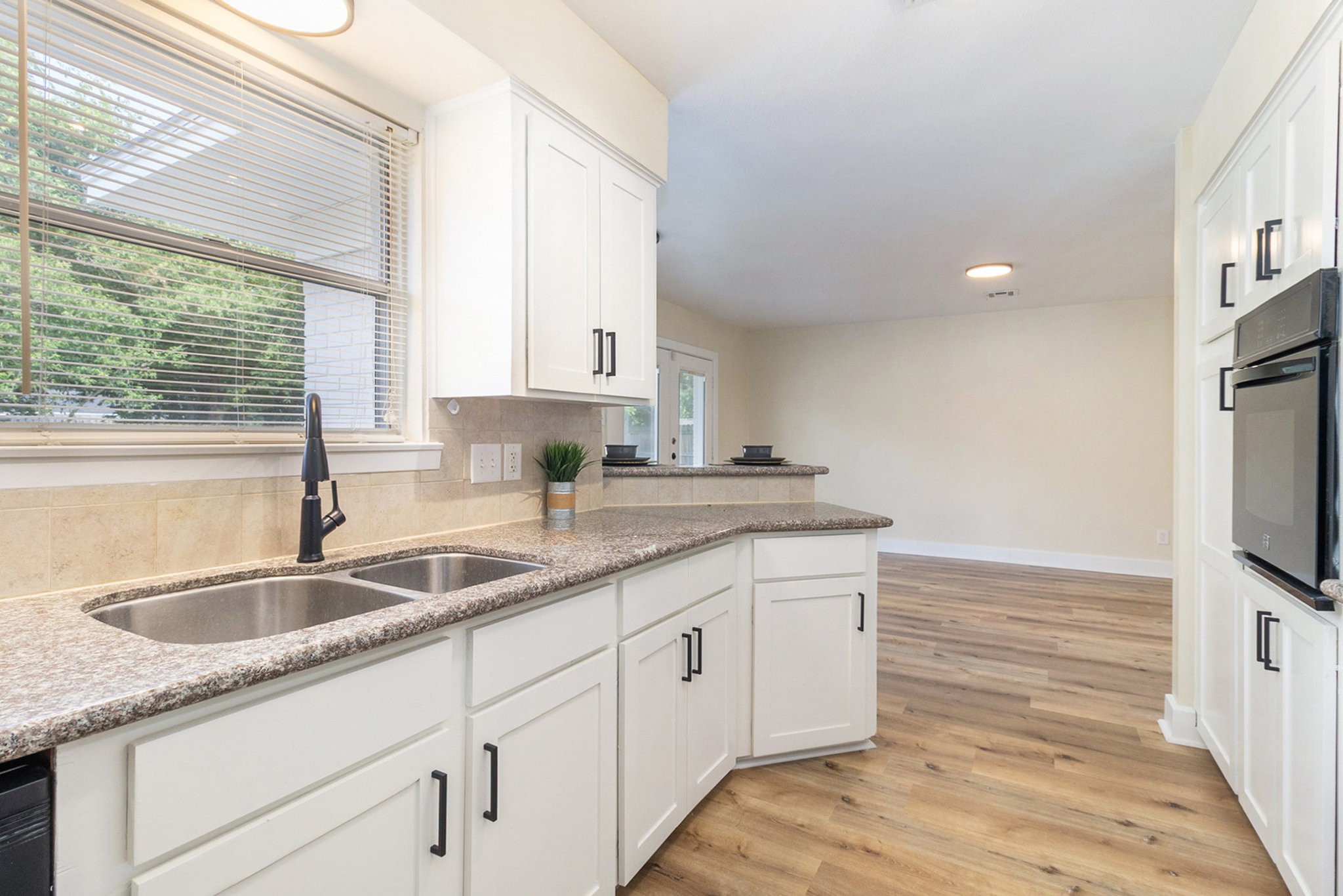 10331 Collingswood Road La Porte, TX 77571 - Photo 6 of 29 a kitchen with granite countertop a sink and a window