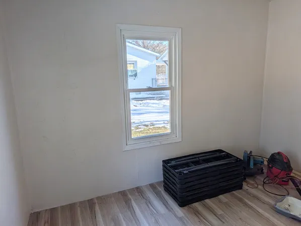 a room with a dresser and a window