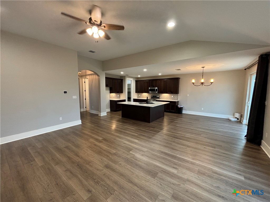 110 Hiram Cook Blanco, TX 78606 - Photo 31 of 46 a living room with kitchen island furniture and a chandelier