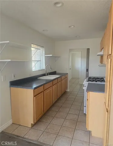 a kitchen with stainless steel appliances granite countertop a sink and a refrigerator