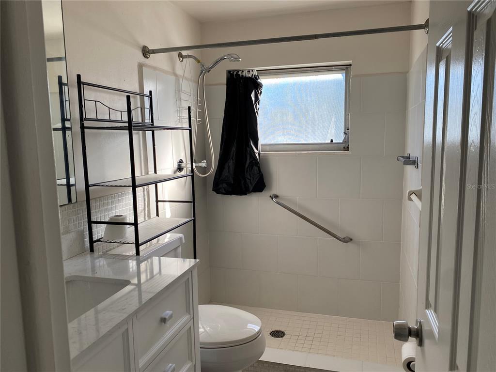 911 Washington Avenue Southwest, Unit 212 Largo, FL 33770 - Photo 11 of 20 a bathroom with a shower toilet and sink