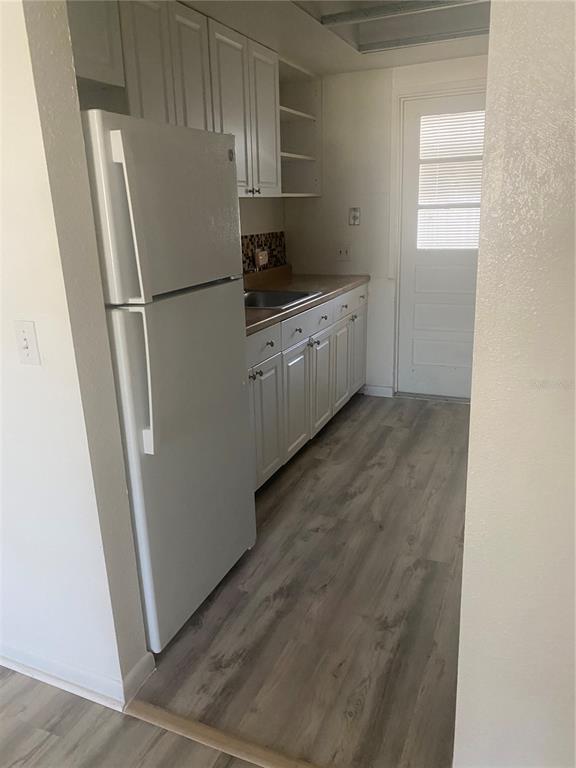 911 Washington Avenue Southwest, Unit 212 Largo, FL 33770 - Photo 15 of 20 a kitchen with stainless steel appliances a refrigerator and a sink