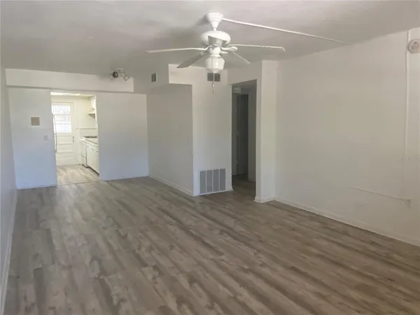 a view of a hallway with wooden floor