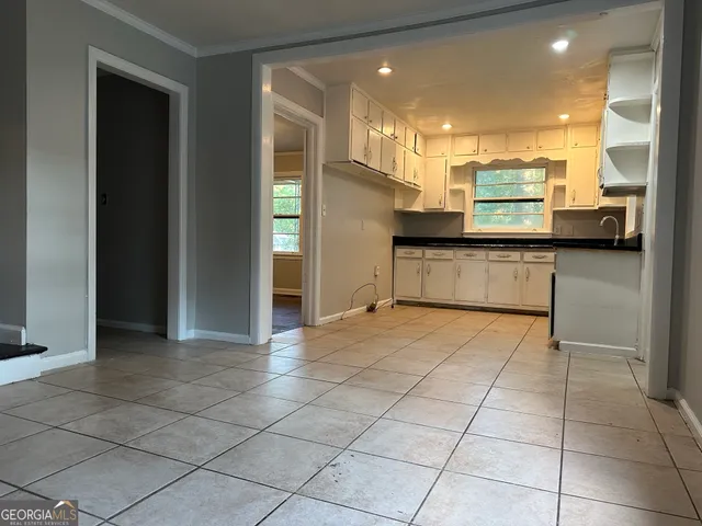 a kitchen with stainless steel appliances kitchen island granite countertop a refrigerator and a stove top oven