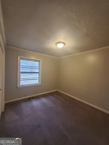 an empty room with a empty space and windows