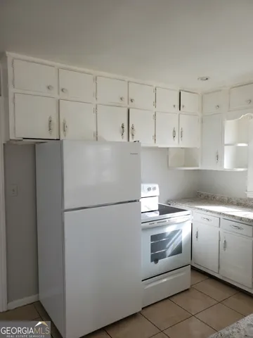a white refrigerator freezer sitting inside of a kitchen