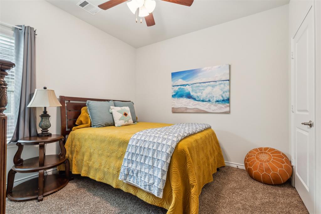 2607 Pinckney Court Forney, TX 75126 - Photo 12 of 27 a bedroom with a bed and a chandelier