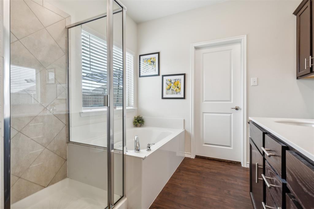 2607 Pinckney Court Forney, TX 75126 - Photo 10 of 27 a bathroom with a tub and shower